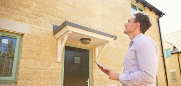 Surveyor outside a modern new home