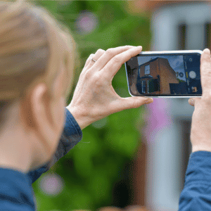 A surveyor taking a photo of a property
