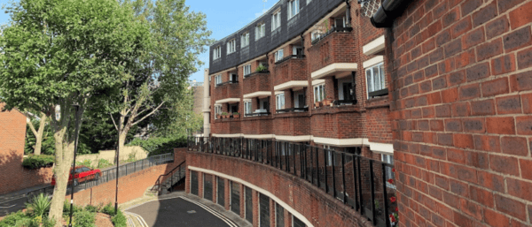 Image shows social housing block of flats.