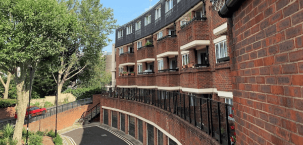 Image shows social housing block of flats.