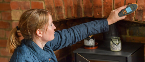 Image shows a residential surveyor testing for damp.